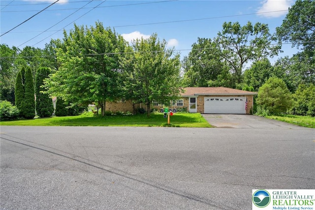 4157 Butternut Dr, Lehigh Twp, PA 18088 - view of front of house with driveway, a garage, and a front yard