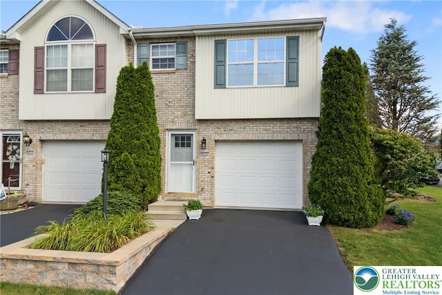4220 Cheyenne Ct, North Whitehall Twp, PA 18078 - view of front of property with asphalt driveway, brick siding, and a garage