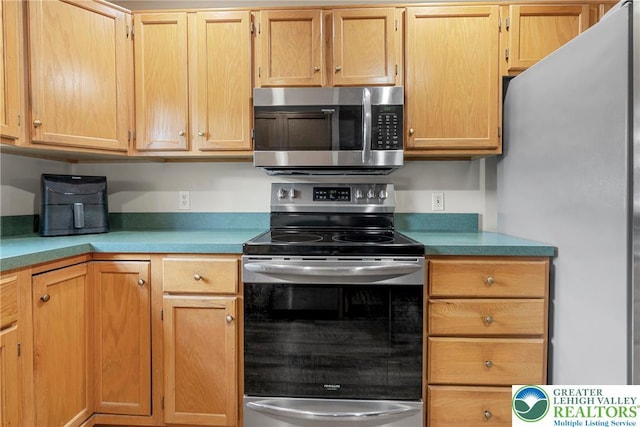 4220 Cheyenne Ct, North Whitehall Twp, PA 18078 - kitchen featuring appliances with stainless steel finishes, light countertops, and light brown cabinets