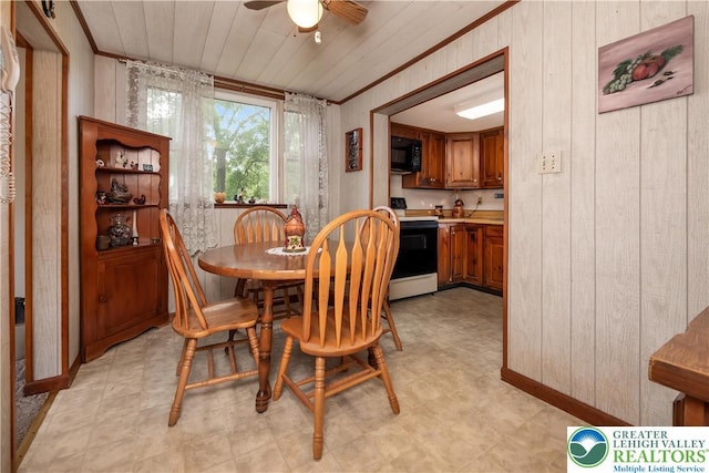 1155 Lake Minsi Dr, Upper Mt Bethel Twp, PA 18013 - dining room with wooden walls, ceiling fan, light floors, and crown molding