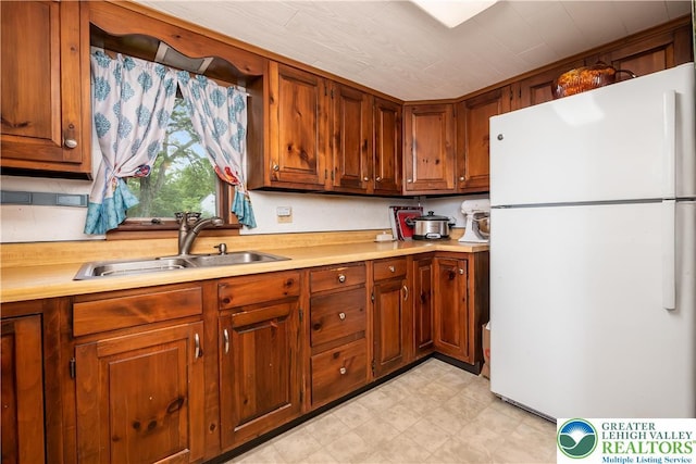 1155 Lake Minsi Dr, Upper Mt Bethel Twp, PA 18013 - kitchen featuring freestanding refrigerator, light countertops, light flooring, and brown cabinetry