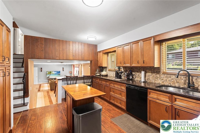 1048 N 27th St, Allentown City, PA 18104 - kitchen featuring dishwasher, dark wood-type flooring, decorative backsplash, brown cabinetry, and wood walls