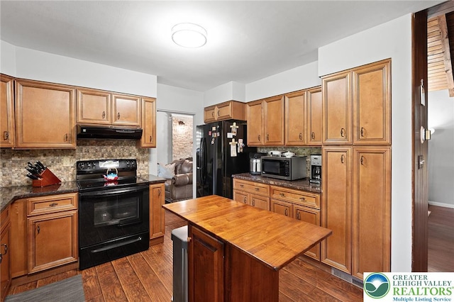 1048 N 27th St, Allentown City, PA 18104 - kitchen featuring black appliances, under cabinet range hood, butcher block countertops, decorative backsplash, and dark wood-style floors