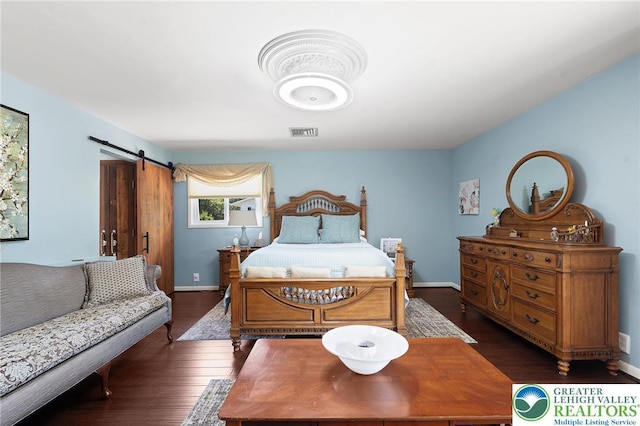 1048 N 27th St, Allentown City, PA 18104 - bedroom with a barn door and hardwood / wood-style flooring