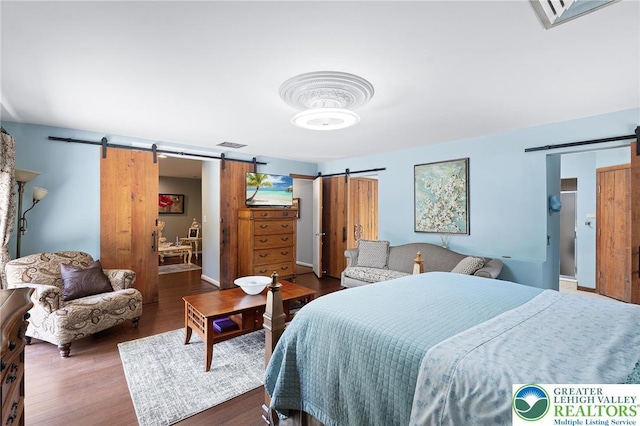 1048 N 27th St, Allentown City, PA 18104 - bedroom with a barn door and wood finished floors