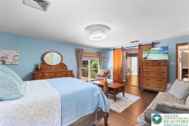 1048 N 27th St, Allentown City, PA 18104 - bedroom featuring a barn door, dark wood-style flooring, and access to exterior