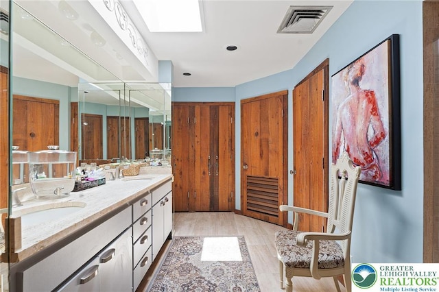 1048 N 27th St, Allentown City, PA 18104 - bathroom with double vanity and wood finished floors