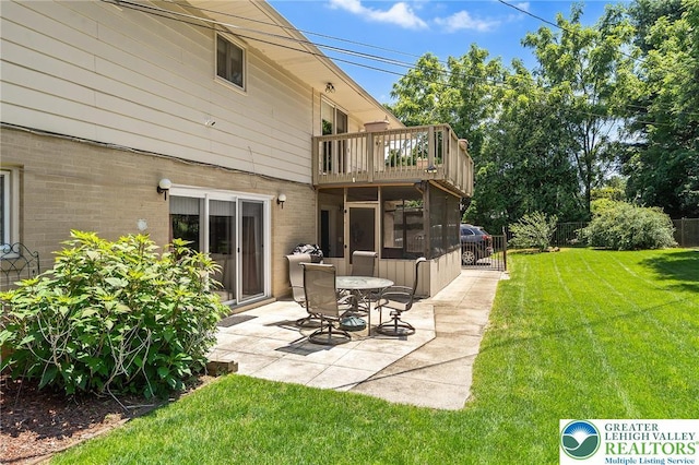 1048 N 27th St, Allentown City, PA 18104 - back of property with a balcony, a patio area, brick siding, and a sunroom