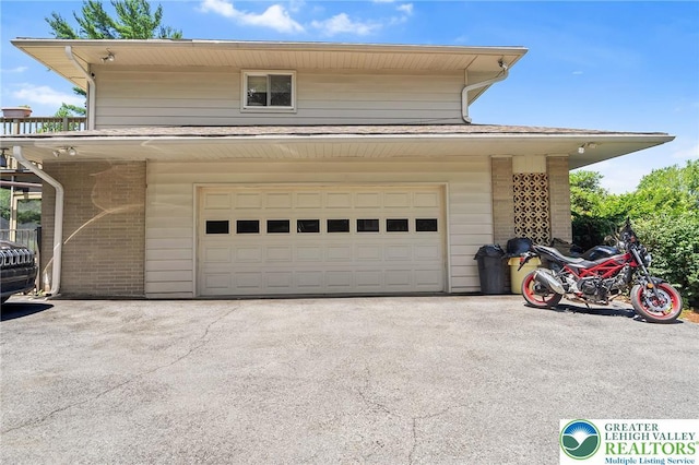 1048 N 27th St, Allentown City, PA 18104 - view of property exterior with brick siding, a garage, and driveway