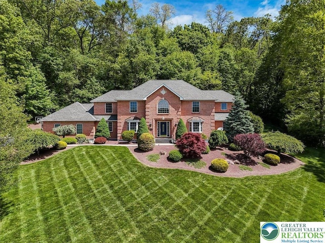 1376 Buck Ridge Dr, Hamilton Twp, PA 18360 - georgian-style home featuring a front yard and brick siding