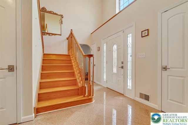 1376 Buck Ridge Dr, Hamilton Twp, PA 18360 - foyer entrance featuring healthy amount of natural light, stairs, a high ceiling, and granite floors