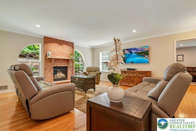 1376 Buck Ridge Dr, Hamilton Twp, PA 18360 - living area featuring light wood-style flooring, a fireplace, recessed lighting, and crown molding