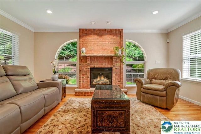 1376 Buck Ridge Dr, Hamilton Twp, PA 18360 - living area featuring wood finished floors, crown molding, recessed lighting, and a brick fireplace