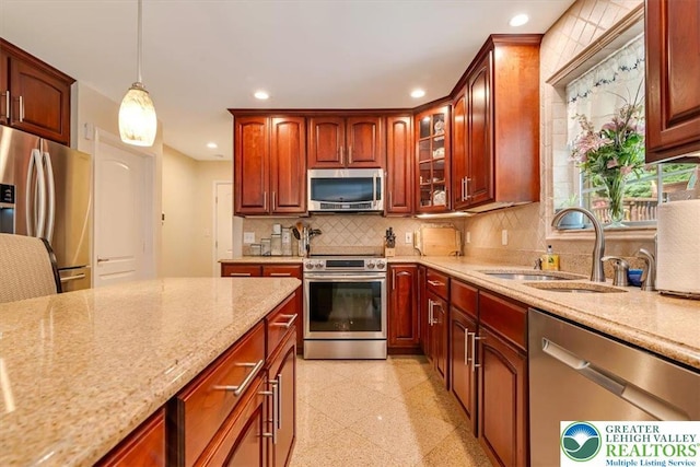 1376 Buck Ridge Dr, Hamilton Twp, PA 18360 - kitchen featuring appliances with stainless steel finishes, recessed lighting, light stone counters, tasteful backsplash, and decorative light fixtures