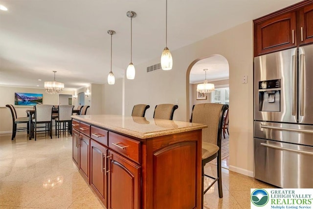 1376 Buck Ridge Dr, Hamilton Twp, PA 18360 - kitchen featuring stainless steel refrigerator with ice dispenser, a chandelier, arched walkways, a breakfast bar, and granite tiled floors