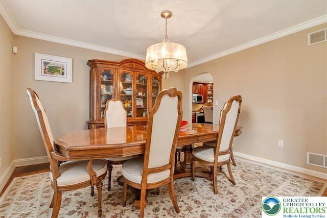 1376 Buck Ridge Dr, Hamilton Twp, PA 18360 - dining room with a chandelier, ornamental molding, arched walkways, and light wood finished floors