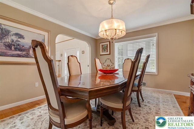 1376 Buck Ridge Dr, Hamilton Twp, PA 18360 - dining room featuring a chandelier, arched walkways, ornamental molding, and light wood finished floors