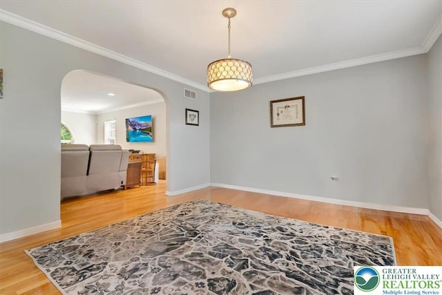 1376 Buck Ridge Dr, Hamilton Twp, PA 18360 - unfurnished room with arched walkways, ornamental molding, and wood finished floors