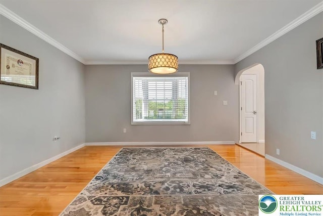 1376 Buck Ridge Dr, Hamilton Twp, PA 18360 - empty room featuring wood finished floors, arched walkways, and ornamental molding