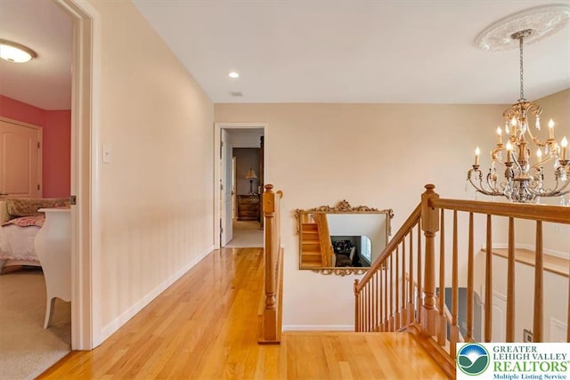 1376 Buck Ridge Dr, Hamilton Twp, PA 18360 - hallway featuring an upstairs landing, wood finished floors, and a chandelier