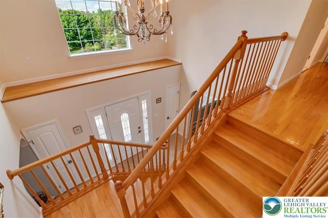 1376 Buck Ridge Dr, Hamilton Twp, PA 18360 - stairs featuring a towering ceiling, wood finished floors, and a chandelier