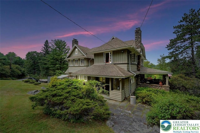 664 Griscom Rd, Barrett Twp, PA 18323 - victorian house with a chimney, a porch, board and batten siding, and a front yard
