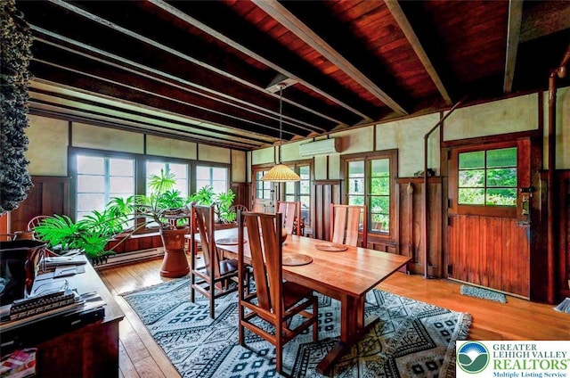 664 Griscom Rd, Barrett Twp, PA 18323 - dining space with an AC wall unit, hardwood / wood-style floors, beam ceiling, wainscoting, and a baseboard radiator