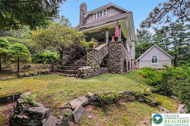 664 Griscom Rd, Barrett Twp, PA 18323 - view of front of house with stairway, a chimney, and a front lawn