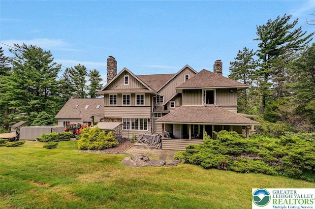 664 Griscom Rd, Barrett Twp, PA 18323 - back of house with a chimney, a yard, stone siding, and board and batten siding