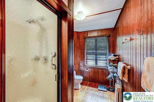 664 Griscom Rd, Barrett Twp, PA 18323 - bathroom featuring a stall shower, wood finished floors, and wooden walls