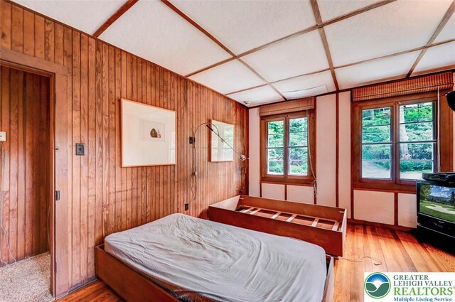 664 Griscom Rd, Barrett Twp, PA 18323 - bedroom featuring wood finished floors and wooden walls