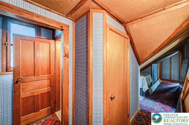 664 Griscom Rd, Barrett Twp, PA 18323 - corridor with lofted ceiling, wallpapered walls, and carpet