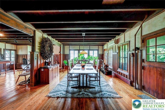 664 Griscom Rd, Barrett Twp, PA 18323 - dining space with wood-type flooring, wood walls, beamed ceiling, wainscoting, and a wall unit AC