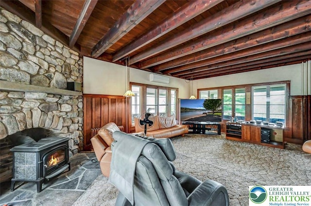 664 Griscom Rd, Barrett Twp, PA 18323 - living room with a wall unit AC, a wood stove, a wainscoted wall, and a wood ceiling with exposed beams