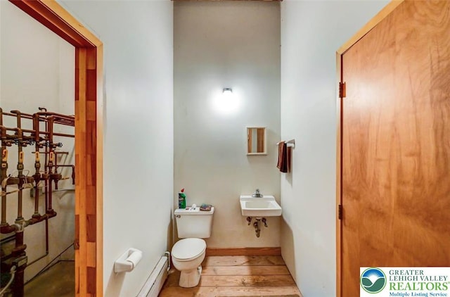 664 Griscom Rd, Barrett Twp, PA 18323 - bathroom with a baseboard radiator and hardwood / wood-style floors