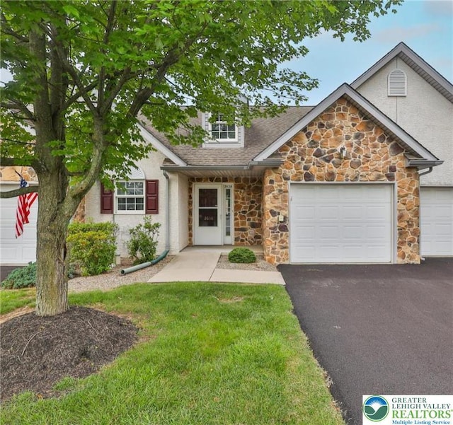 2638 Harvest Dr S, Forks Twp, PA 18040 - view of front of house with stone siding, asphalt driveway, an attached garage, roof with shingles, and a front yard