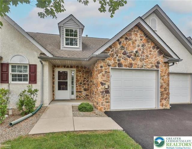 2638 Harvest Dr S, Forks Twp, PA 18040 - view of front of property with stone siding, driveway, a garage, and roof with shingles