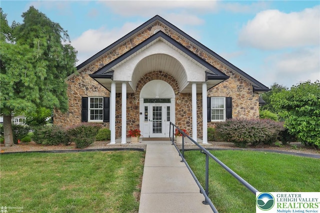 2638 Harvest Dr S, Forks Twp, PA 18040 - view of front of home featuring stone siding, french doors, and a front lawn