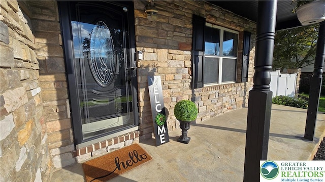 1136 Ashbourne Dr, Muhlenberg Twp, PA 19605 - entrance to property featuring stone siding and covered porch