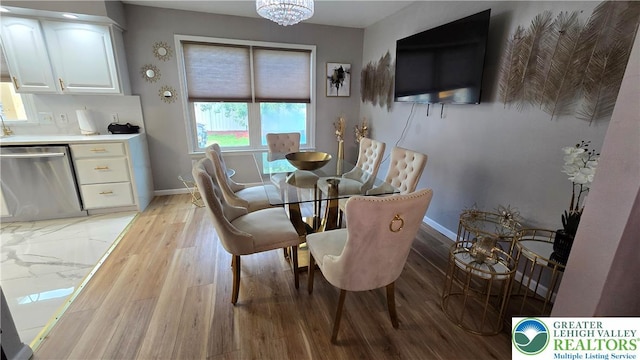 1136 Ashbourne Dr, Muhlenberg Twp, PA 19605 - dining room with light wood-style floors and a chandelier