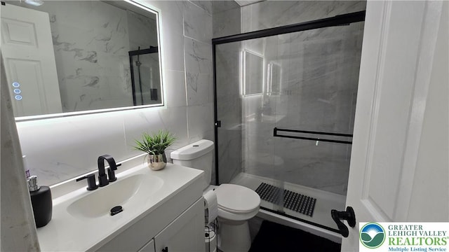 1136 Ashbourne Dr, Muhlenberg Twp, PA 19605 - bathroom with a stall shower, vanity, and tile walls