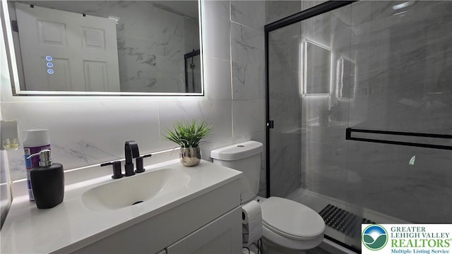1136 Ashbourne Dr, Muhlenberg Twp, PA 19605 - bathroom featuring tile walls, vanity, a shower stall, and backsplash