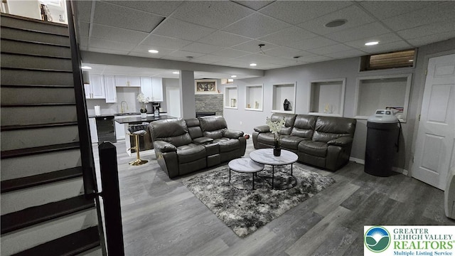 1136 Ashbourne Dr, Muhlenberg Twp, PA 19605 - living area featuring a paneled ceiling and dark wood-style floors