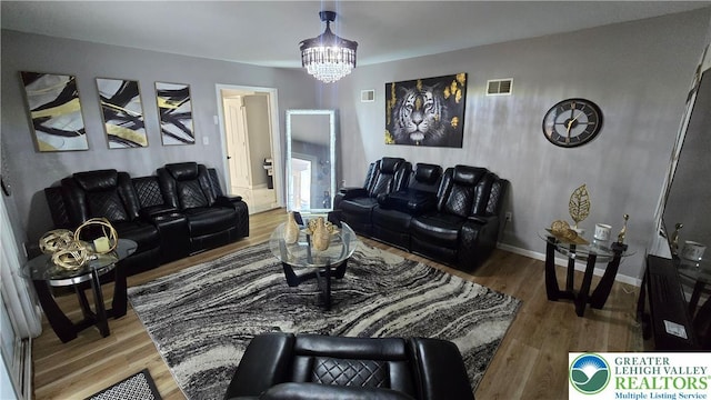 1136 Ashbourne Dr, Muhlenberg Twp, PA 19605 - living room featuring a chandelier and wood finished floors