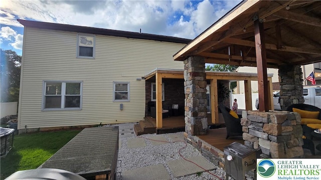 1136 Ashbourne Dr, Muhlenberg Twp, PA 19605 - rear view of property featuring a deck and a patio