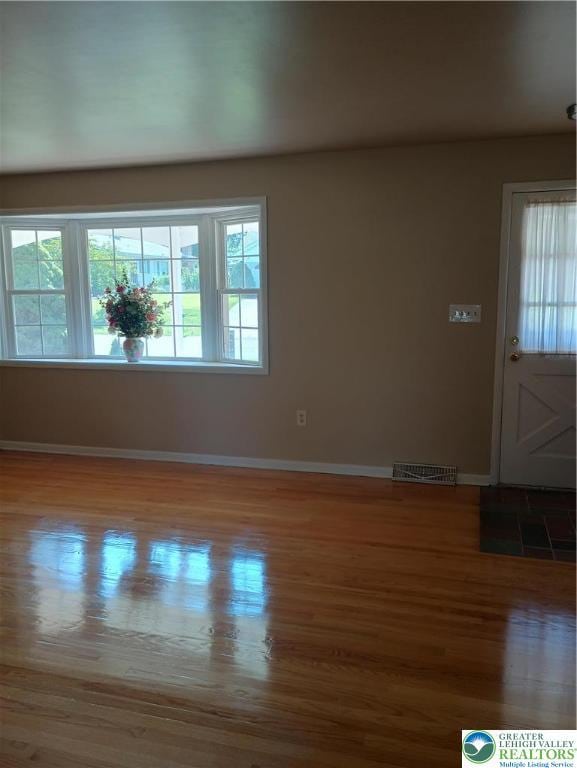 6059 Clubhouse Ln, Lower Macungie Twp, PA 18106 - spare room featuring wood finished floors and plenty of natural light
