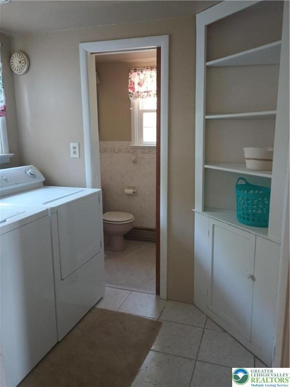 6059 Clubhouse Ln, Lower Macungie Twp, PA 18106 - laundry room featuring washing machine and dryer, light tile patterned flooring, built in features, and tile walls