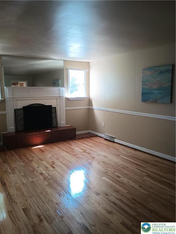 6059 Clubhouse Ln, Lower Macungie Twp, PA 18106 - unfurnished living room with a premium fireplace and wood finished floors