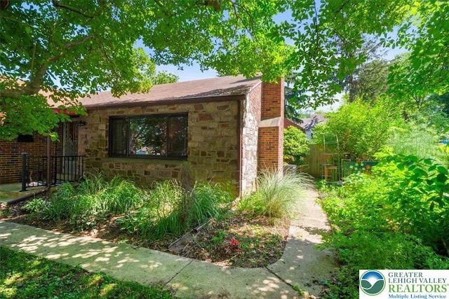 1321 W Union Blvd, Bethlehem City, PA 18018 - view of property exterior featuring stone siding and a chimney