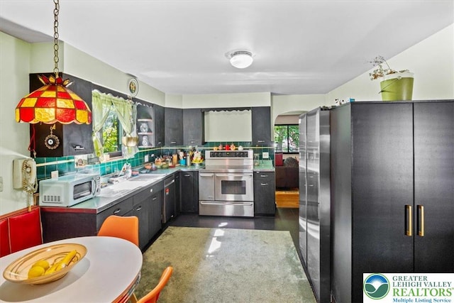 1321 W Union Blvd, Bethlehem City, PA 18018 - kitchen featuring stainless steel appliances, tasteful backsplash, arched walkways, and pendant lighting